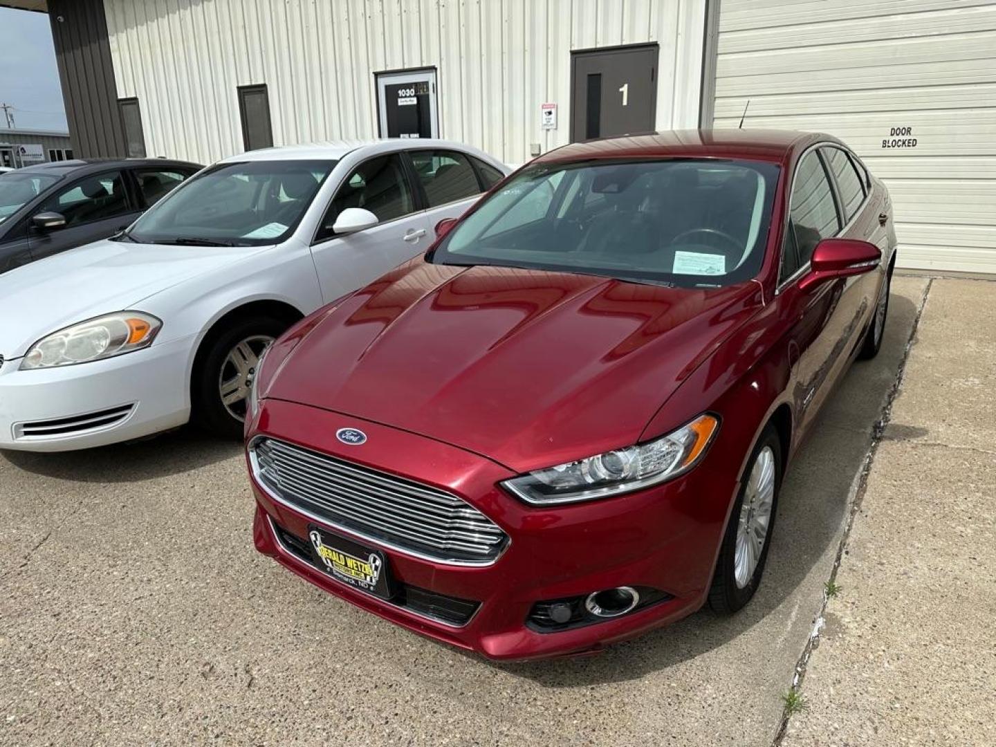 2013 RED FORD FUSION TITANIUM 4DR (3FA6POSU7DR) , Automatic transmission, located at 1030 S. 22nd St., Bismarck, ND, 58504, (701) 258-0022, 46.793560, -100.758118 - FUSION HYBRID - Photo#0